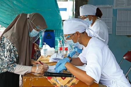 Millions vote in Indonesia as experts warn of surge in infections