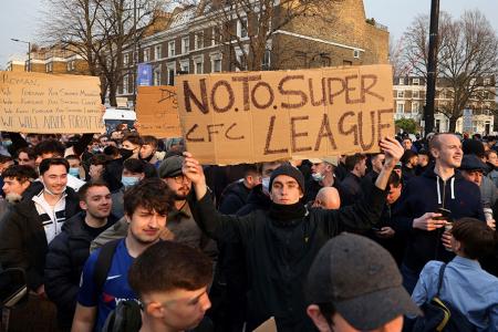 Football supporters demonstrate against the proposed European Super League outside of Stamford Bridge football stadium in London