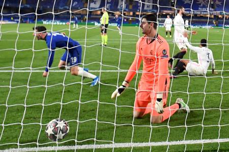 Real Madrid&#039;s Thibaut Courtois reacts as Chelsea&#039;s Mason Mount celebrates scoring their second goal