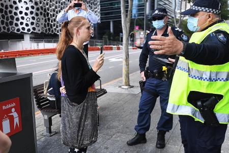 Brisbane extends Covid-19 lockdown while army patrols Sydney