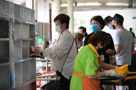 Most patrons at some hawker centres clear their own trays