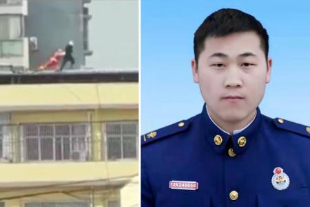 Firefighter dies while trying to save woman from jumping off building in China