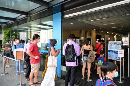 Visitors queue at libraries on first day of jab status checks