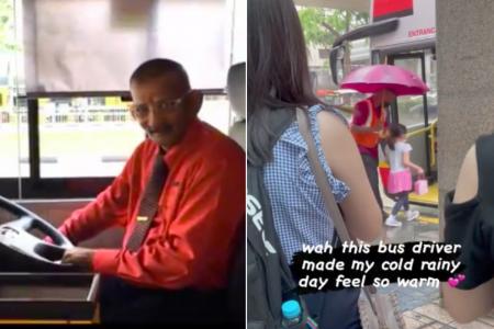Going the extra mile: Bus captain shelters passengers with brolly on a rainy day