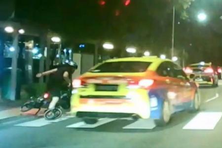 Cyclist loses balance at zebra crossing as taxi whizzes past