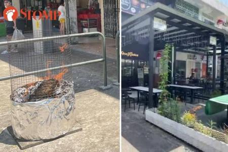 Flying ashes from Hungry Ghost burnt offerings drive away outdoor diners at Jalan Kayu