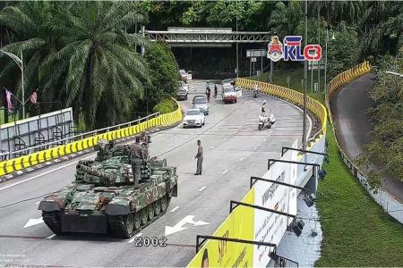 Like a scene out of a video game, a tank breaks down in the middle of Kuala Lumpur traffic
