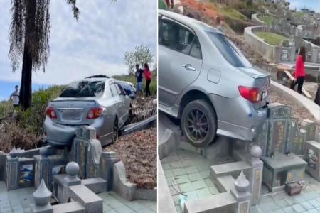 Car reverses into Chinese gravestone in Perak
