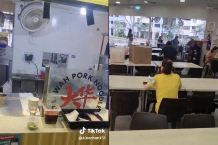 Tai Wah Pork Noodle staff casually eats breakfast while seemingly ignoring customers