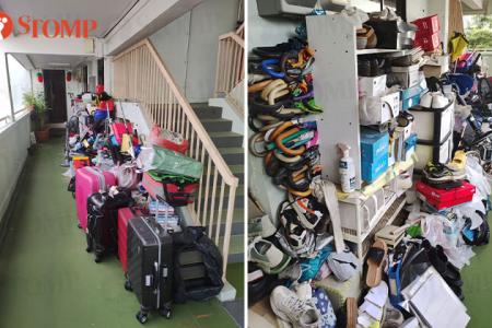 AMK resident struggles to push his wheelchair-bound mother along corridor cluttered with belongings