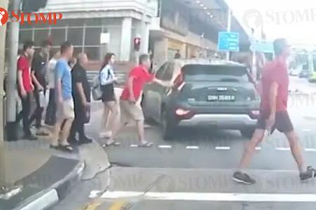 Man 'slaps' car that failed to stop for pedestrians, both he and driver get criticised