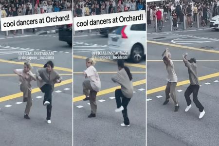 Young women show off dance moves while crossing crowded Orchard Road street