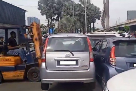 Frustrated owner uses forklift to move cars blocking workshop