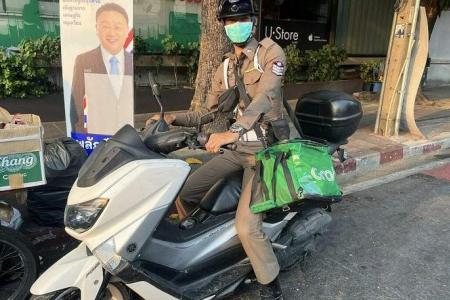 Thai policeman delivers Grab order on behalf of rider who crashes bike