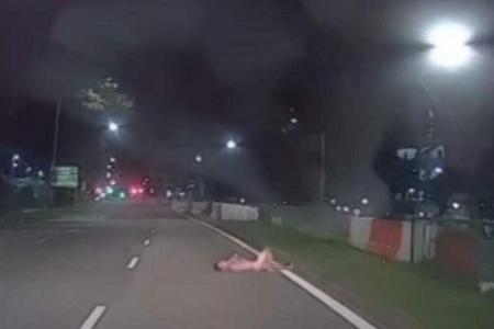 Man arrested after video shows him naked, lying on road in Sembawang