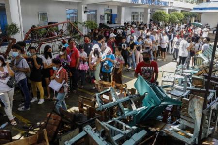 Tempers flare as machines glitch, queues stretch for hours as Filipinos hold out for right to vote