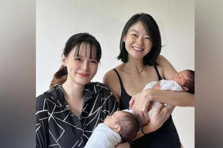 Jayley Woo and Sheila Sim cradle their newborn daughters in a photo