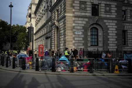 'We couldn't miss this': Thousands camp out for Queen Elizabeth's funeral