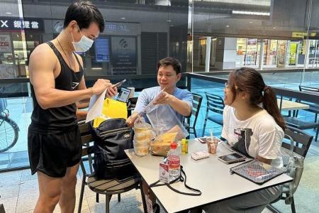 Volunteers in Singapore help collect and deliver postal ballots for Malaysia state elections