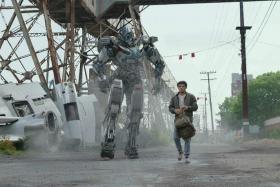 The Autobot Mirage (voiced by Pete Davidson) and Noah (Anthony Ramos) in Transformers: Rise Of The Beasts.