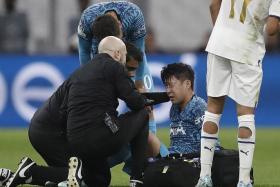 Tottenham&#039;s Son Heung-Min Son receives medical assistance during the Champions League match against Olympique Marseille.