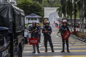 Unit officers from Royal Malaysia Police guard the entrance of National Palace in Kuala Lumpur on Nov 22, 2022.