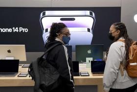 Customers look at Apple products at a Best Buy in Alexandria, Virginia, in the US, on Black Friday.