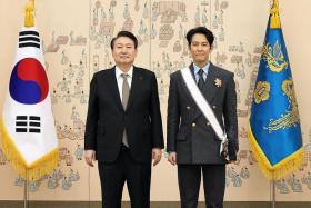 South Korean President Yoon Suk-yeol (left) with actor Lee Jung-jae after conferring the Geumgwan Order of Cultural Merit on Dec 27, 2022.