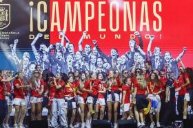 Spain's players dancing on stage in Madrid as they celebrate with supporters after winning the Women's World Cup.