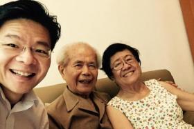 Finance Minister Lawrence Wong with his parents, in a photo posted on his Facebook page in 2015.