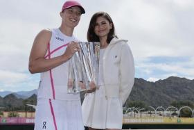 Polish tennis star Iga Swiatek (left) and actress Zendaya with the Championship trophy at the BNP Paribas Open tennis tournament on March 17.