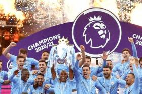 Manchester City&#039;s Fernandinho lifts the trophy as they celebrate winning the Premier League, in May 2021.