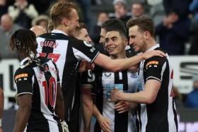 Newcastle United&#039;s Chris Wood celebrates scoring their first goal with teammates.