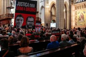 People attend a memorial service for British journalist Dom Phillips and indigenous expert Bruno Pereira, in Sao Paulo, Brazil.