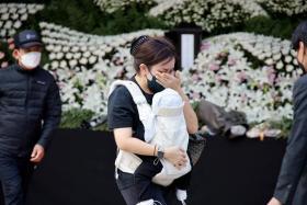 A person mourns at a group memorial for the victims of at the Seoul City Hall Plaza on Oct 31, 2022.