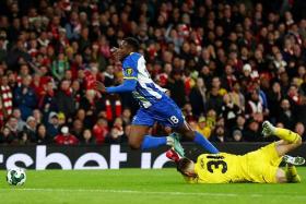 Brighton &amp; Hove Albion&#039;s Danny Welbeck (left) is fouled by Arsenal&#039;s Karl Hein resulting in a penalty being awarded to his side.