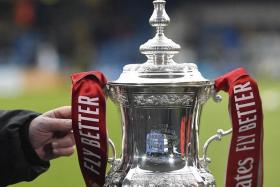 The FA Cup trophy on display before a third round match between Gillingham and Leicester City on Jan 7.