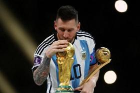Argentina&#039;s Lionel Messi kissing the World Cup trophy after receiving the Golden Ball award at Qatar 2022.