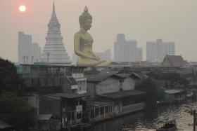 The giant Buddha statue of Wat Paknam Phasi Charoen temple is seen amid air pollution in Bangkok, on Feb 2, 2023.