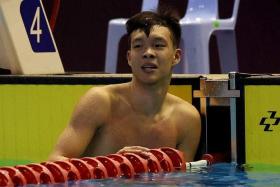 Singapore&#039;s Mikkel Jun Jie Lee reacts after winning the men&#039;s 50m butterfly final.