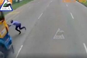 A screengrab from dashcam footage of the incident, which shows the man running across two lanes before an orange-and-blue trailer hits him and then grinds to a halt.