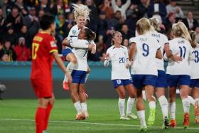 England&#039;s Lauren James celebrates scoring their third goal against China with Alex Greenwood and Katie Zelem.
