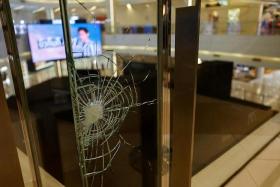A bullet mark is seen on a glass panel at the luxury Siam Paragon shopping mall after Thai police arrested a teenage gunman on Oct 3.
