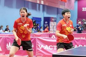 Singapore&#039;s Wong Xin Ru (left) overcomes her mixed doubles quarter-final loss with Koen Pang to partner Zhou Jingyi to victory in their women&#039;s doubles quarter-final against Thailand&#039;s Jinnipa Sawettabut and Tamolwan Khetkhuan.