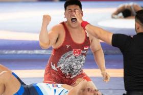 Singapore’s Timothy Loh celebrating after winning gold in the men&#039;s freestyle 125kg at the Cambodia SEA Games.  