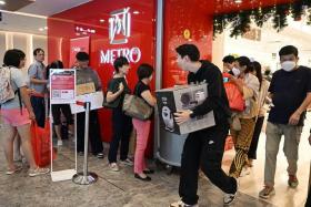 Shoppers leaving the Metro department store in Paragon to queue up for home delivery service during Black Friday on Nov 24.