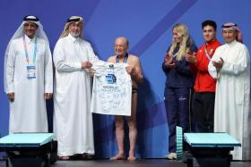 Mr Taghi Askari (centre) after performing his dive at the World Aquatics Championships in Doha on Feb 9.  
