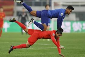 Singapore&#039;s Irfan Fandi challenging China&#039;s Yuning Zhang for the ball during their World Cup qualifying match.
