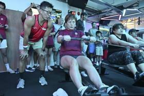 Yee Kok Pheng encourages his wife Kee Su Ling during the inaugural Singapore Indoor Rowing Championships was held on March 30 at The Row Space on Aliwal Street.