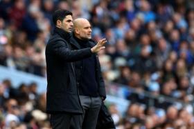 Arsenal manager Mikel Arteta (left) and Manchester City manager Pep Guardiola during the match in Manchester, on March 31.